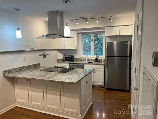 a kitchen with a sink a refrigerator and window