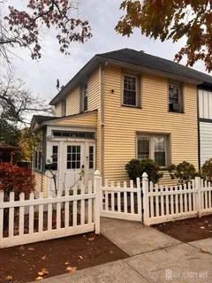a view of a house with wooden fence