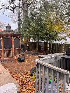 a view of balcony with wooden fence and trees