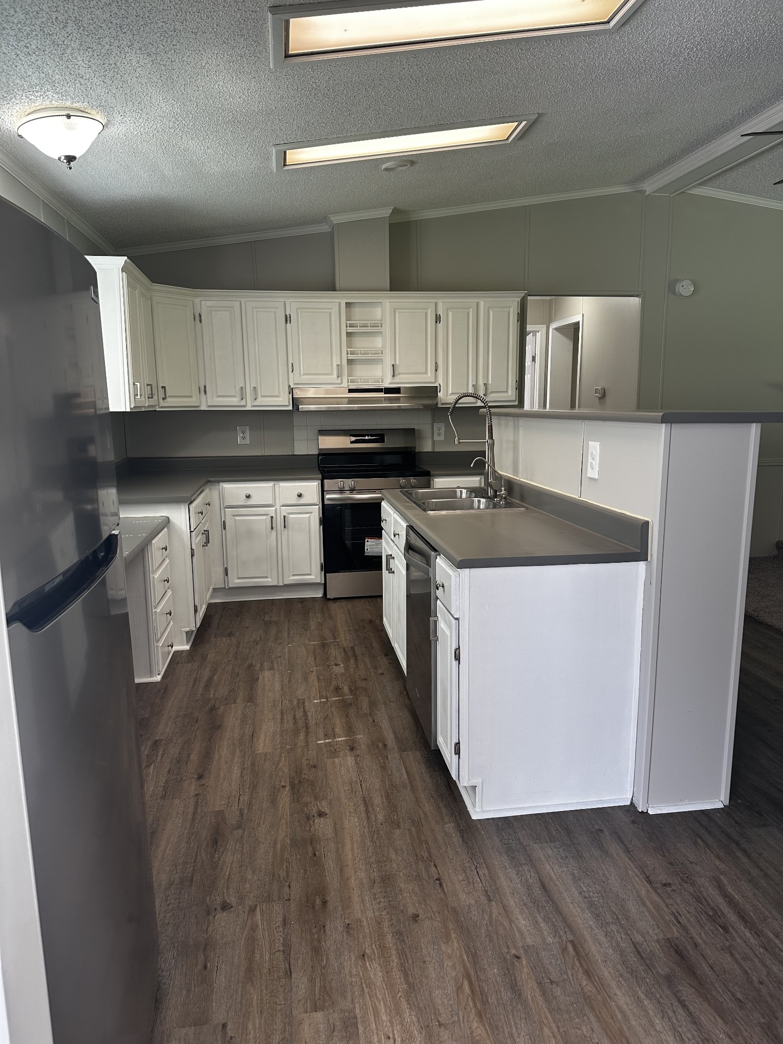 599 Defeated Creek Highway Carthage, TN 37030 - Photo 11 of 22 a kitchen with a stove a sink and a refrigerator