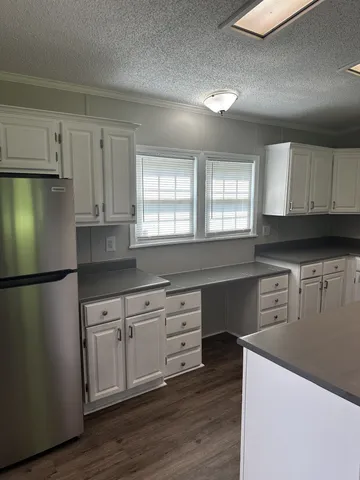 a kitchen with stainless steel appliances a refrigerator sink and cabinets