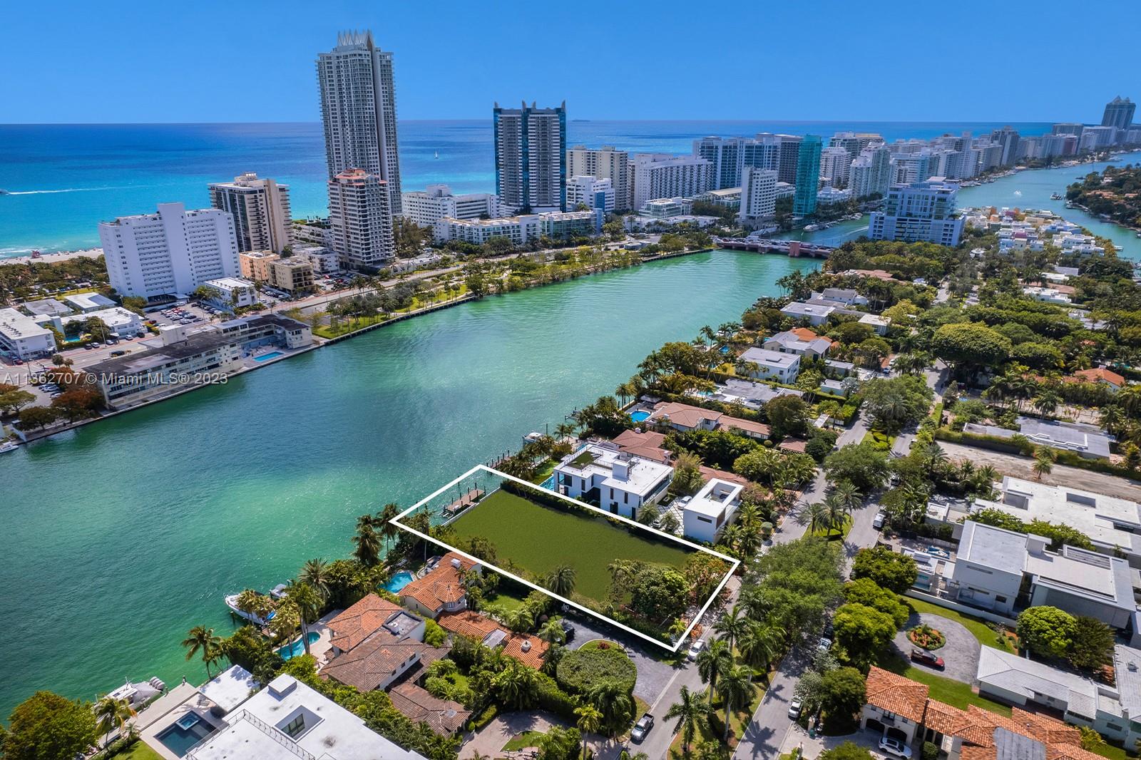 an aerial view of a city with a lake view and a residential building