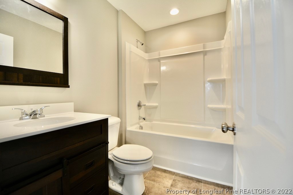 8493 Godwin-Falcon Road Godwin, NC 28344 - Photo 11 of 19 a bathroom with a bathtub shower sink vanity mirror and toilet