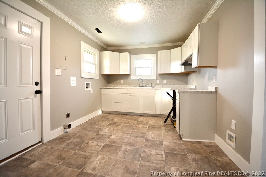 8493 Godwin-Falcon Road Godwin, NC 28344 - Photo 5 of 19 a kitchen with white cabinets and white appliances