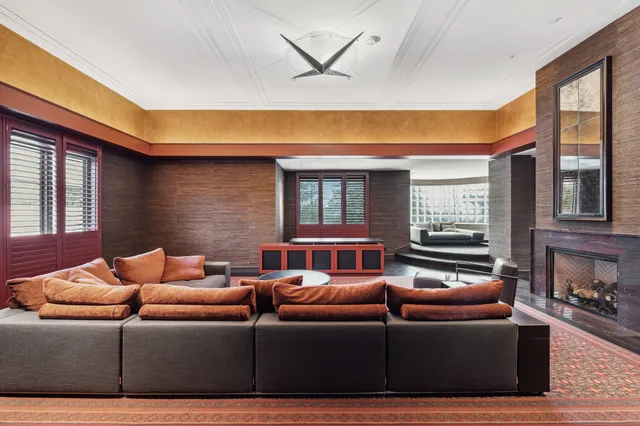a living room with furniture ceiling fan and a window
