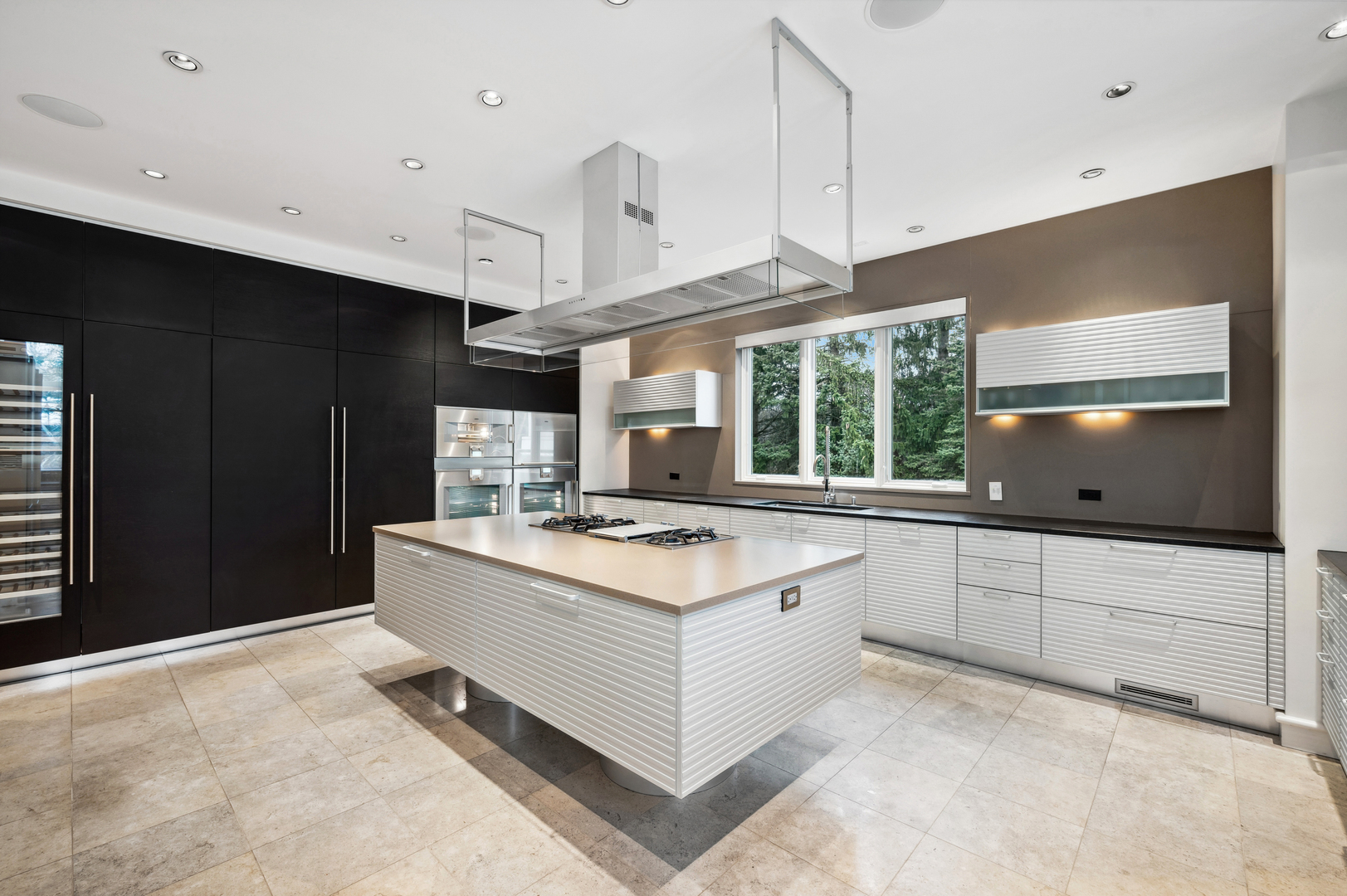 2700 Point Drive Highland Park, IL 60035 - Photo 6 of 22 a kitchen with kitchen island granite countertop a sink stove and a refrigerator