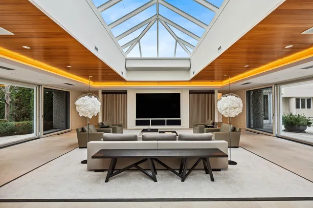 a living room with patio furniture and a large window