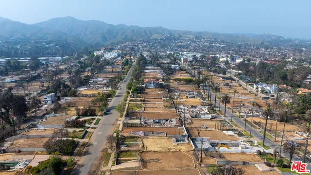an aerial view of residential building with green space