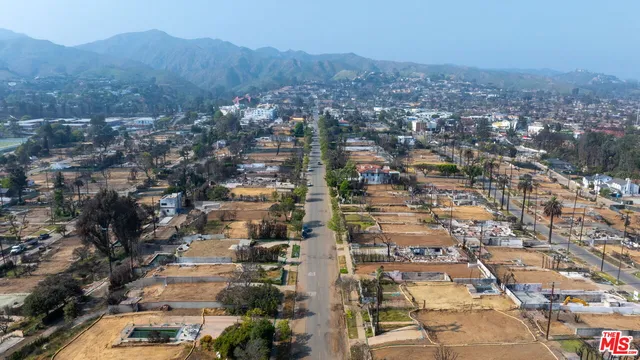 an aerial view of residential houses with city view
