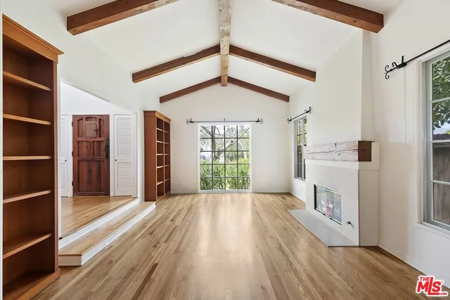a view of a hallway with closet and window