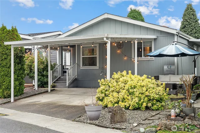 a front view of a house with a garden and plants