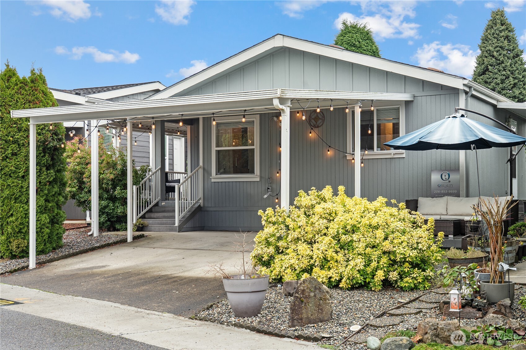 a front view of a house with a garden and plants