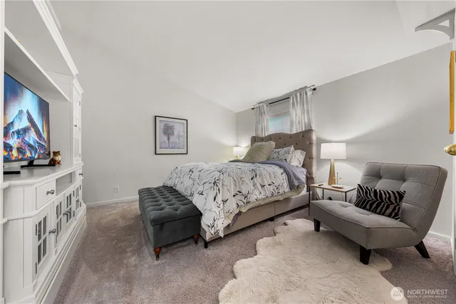 a bedroom with furniture and a flat screen tv