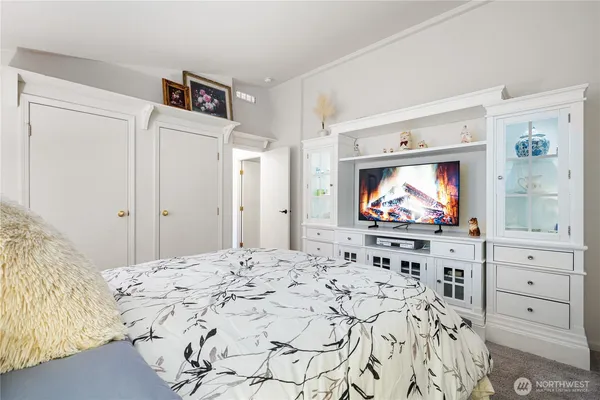a living room with window and a flat screen tv