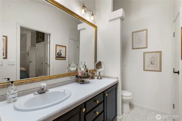 a bathroom with a sink a toilet and mirror
