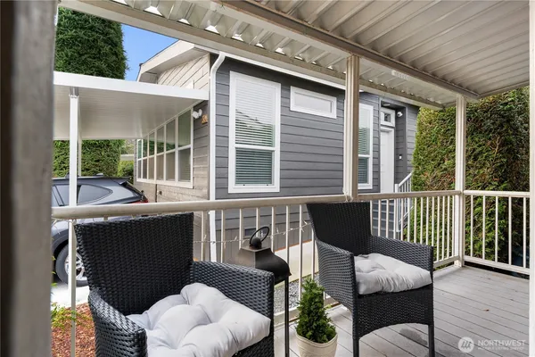 a balcony with furniture and a potted plant