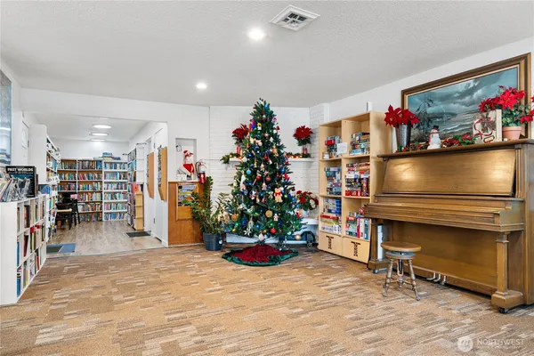 a room with lots of books and a large window
