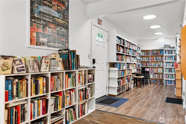a living room with furniture and a book shelf