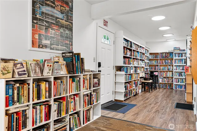a living room with furniture and a book shelf