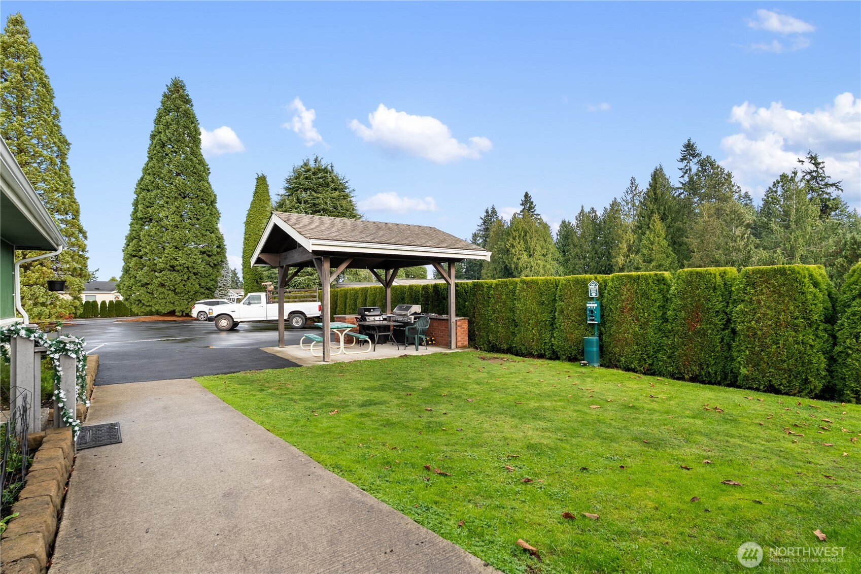 23835 15th Avenue Southeast, Unit 40 Bothell, WA 98021 - Photo 37 of 39 a view of a patio with table and chairs under an umbrella