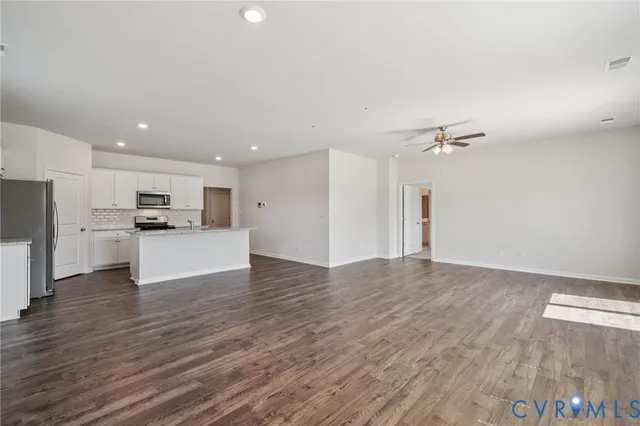 a view of kitchen with refrigerator and microwave