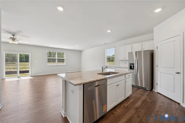 a kitchen with a sink stove and refrigerator
