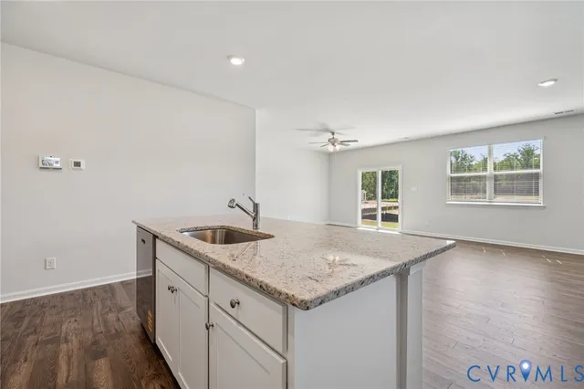 a kitchen with a granite countertop sink and dishwasher