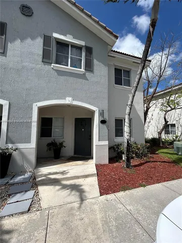 a front view of a house with a yard and a garage