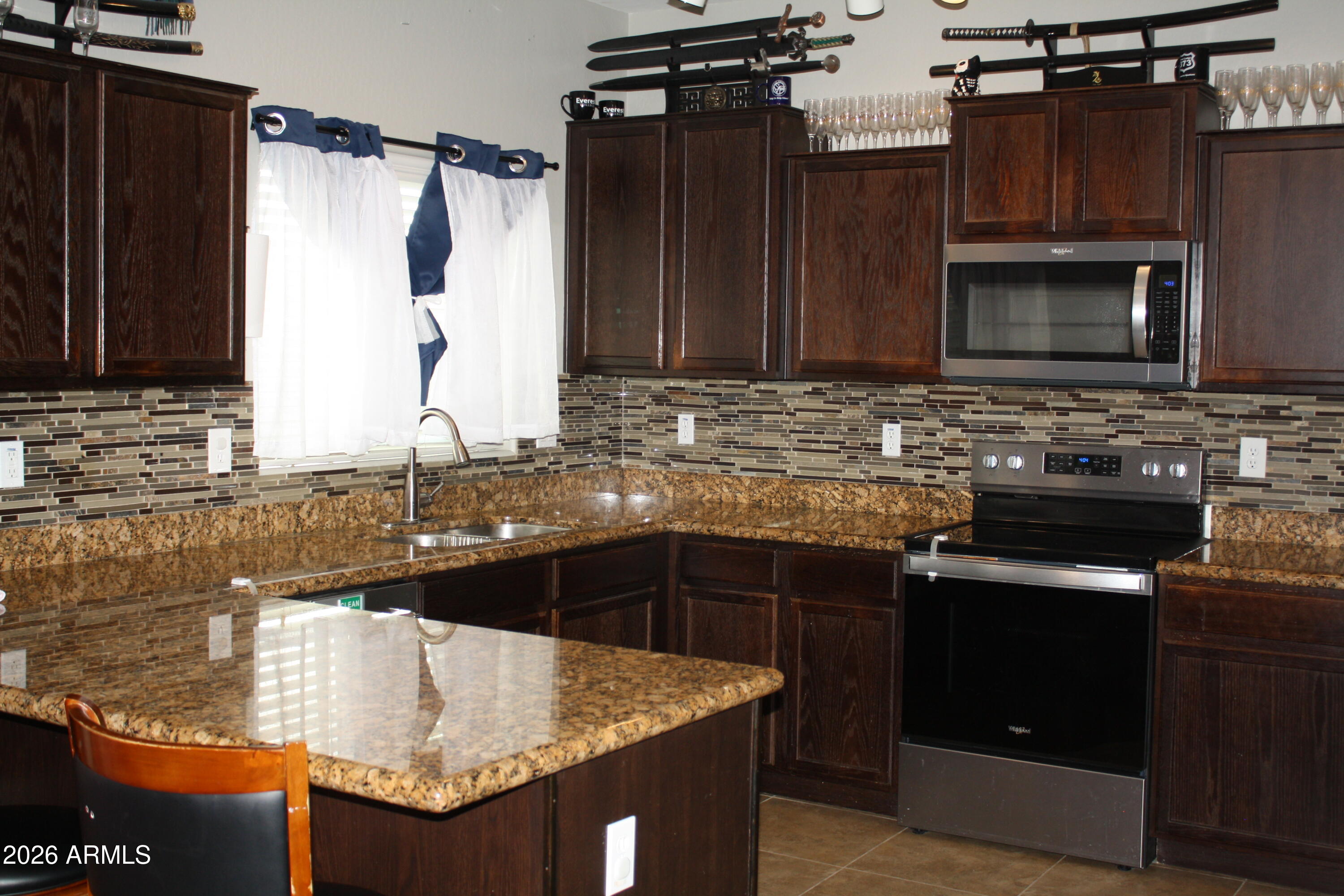 10225 West Camelback Road, Unit 19 Phoenix, AZ 85037 - Photo 7 of 51 a kitchen with a sink stove and microwave