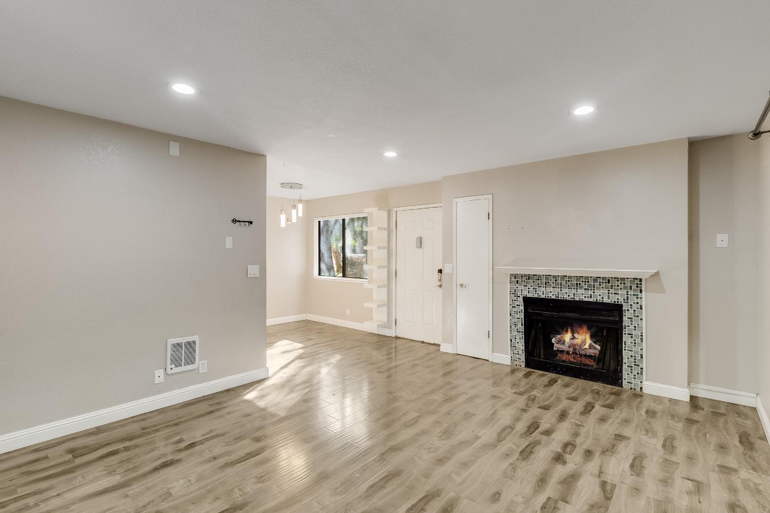 2623 Copa Del Oro Drive Union City, CA 94587 - Photo 19 of 55 a view of an empty room with wooden floor fireplace and a window