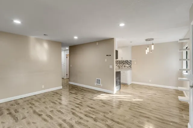 a kitchen with stainless steel appliances kitchen island granite countertop a refrigerator and a stove