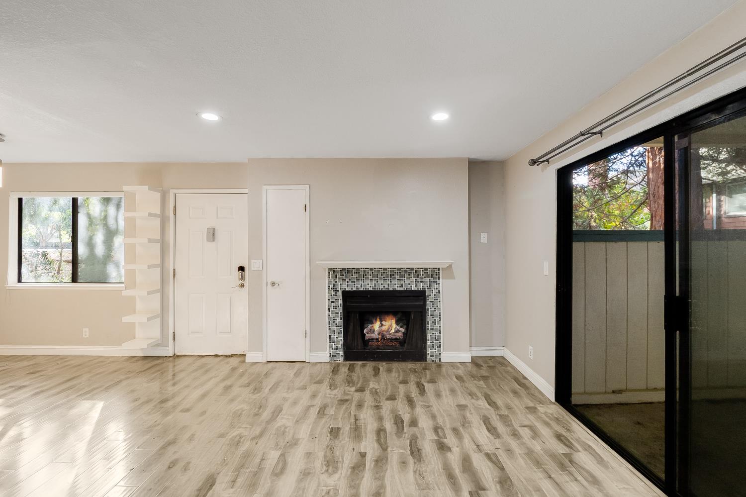 2623 Copa Del Oro Drive Union City, CA 94587 - Photo 22 of 55 a view of an empty room with wooden floor fireplace and a window