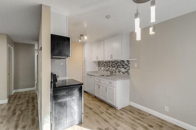 a kitchen with a sink and cabinets