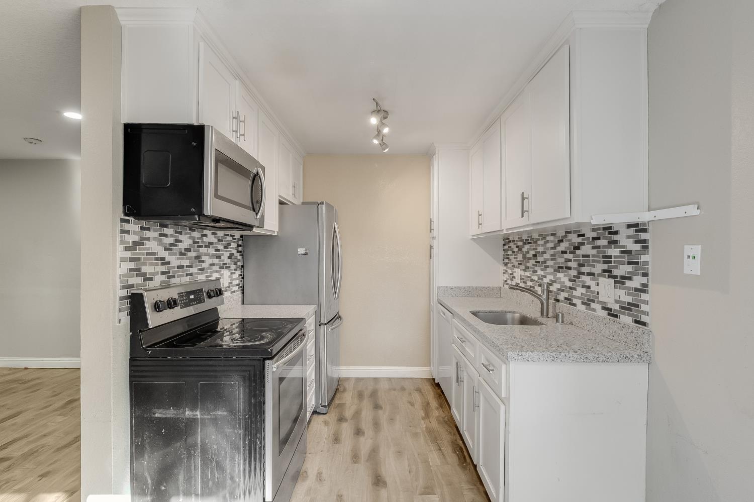 2623 Copa Del Oro Drive Union City, CA 94587 - Photo 25 of 55 a kitchen with stainless steel appliances a stove a sink and a refrigerator