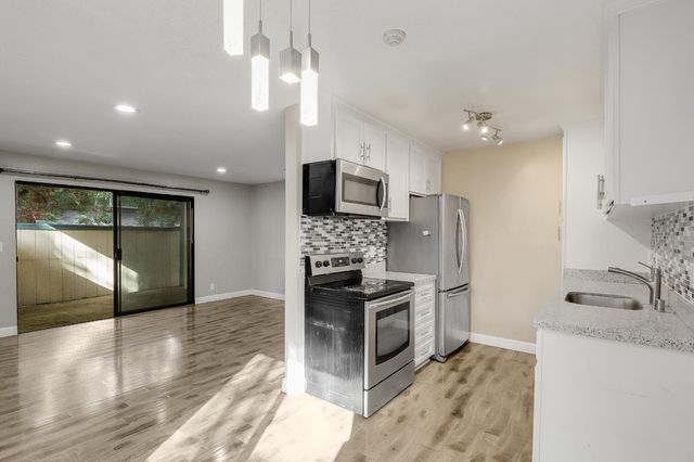 an empty room with wooden floor and fireplace
