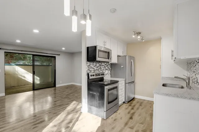 an empty room with wooden floor and fireplace