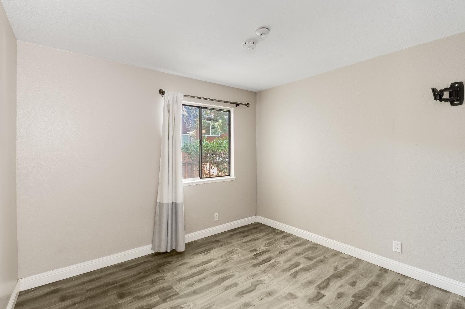 2623 Copa Del Oro Drive Union City, CA 94587 - Photo 32 of 55 an empty room with wooden floor and windows