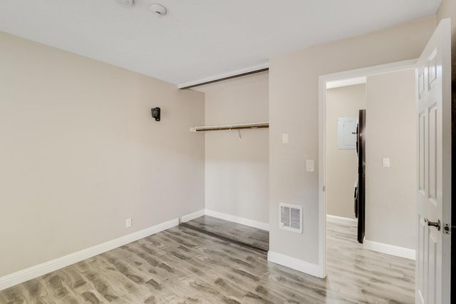 a bathroom with a toilet sink vanity and mirror