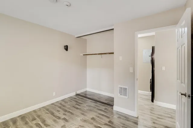 a bathroom with a toilet sink vanity and mirror