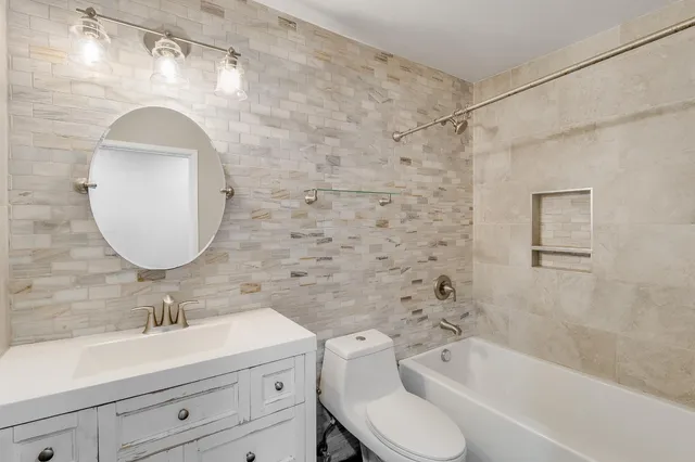 a bedroom with a large bed and a painting on the wall