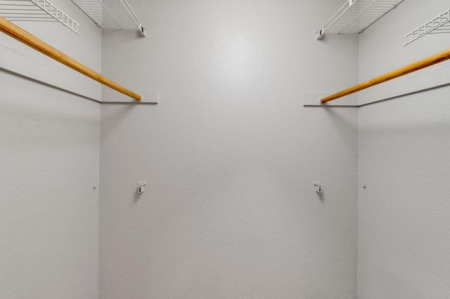 a view of street with house and trees in the background