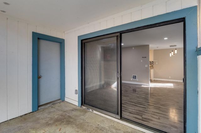 an aerial view of residential houses with outdoor space and trees