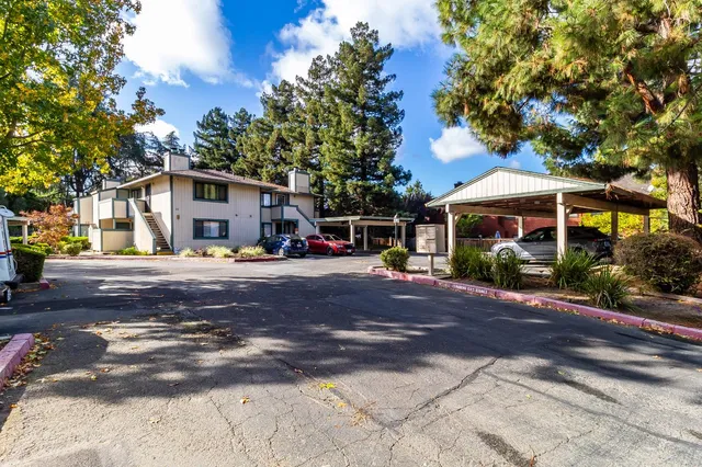 an aerial view of a house with a yard basket ball court and outdoor seating
