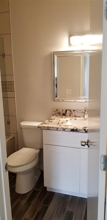 830 Threadneedle Street, Unit 228 Houston, TX 77079 - Photo 6 of 9 a bathroom with a granite countertop toilet sink and mirror