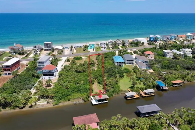an aerial view of a houses with a yard