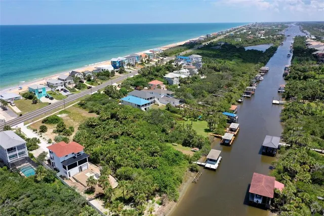 an aerial view of a houses with a yard
