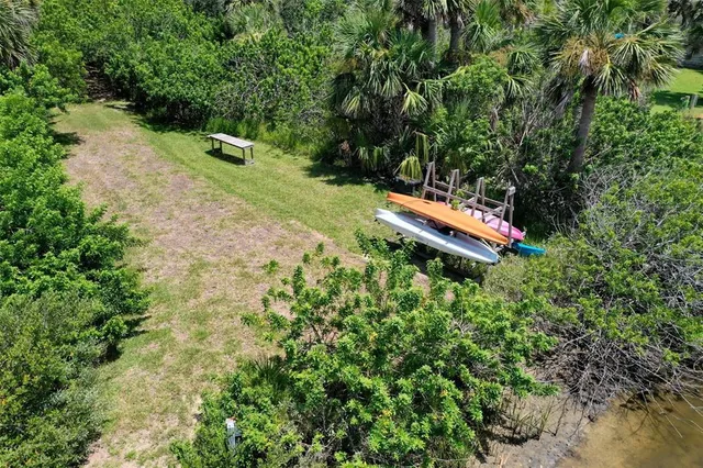 a backyard of a house with a yard and outdoor seating