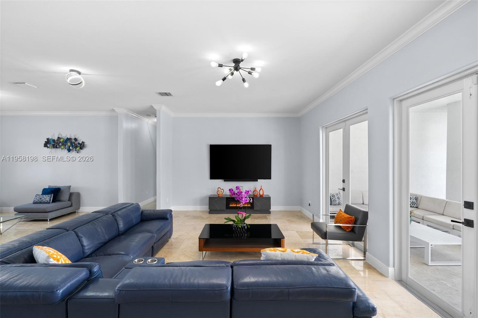 16800 Southwest 190th Street Miami, FL 33187 - Photo 11 of 56 a living room with furniture and a flat screen tv