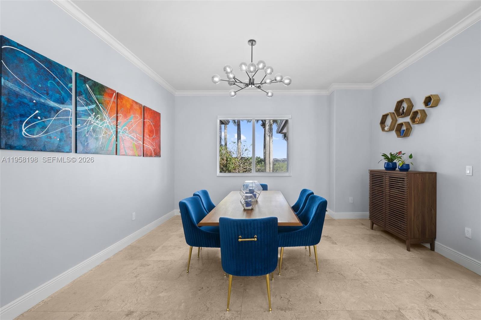 16800 Southwest 190th Street Miami, FL 33187 - Photo 12 of 56 a view of a dining room with furniture and a chandelier