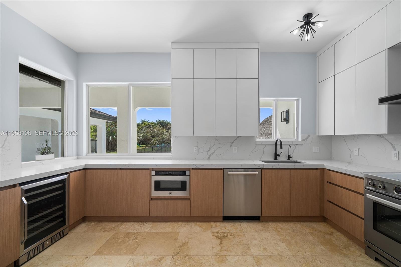 16800 Southwest 190th Street Miami, FL 33187 - Photo 13 of 56 a kitchen with a sink stove and cabinets
